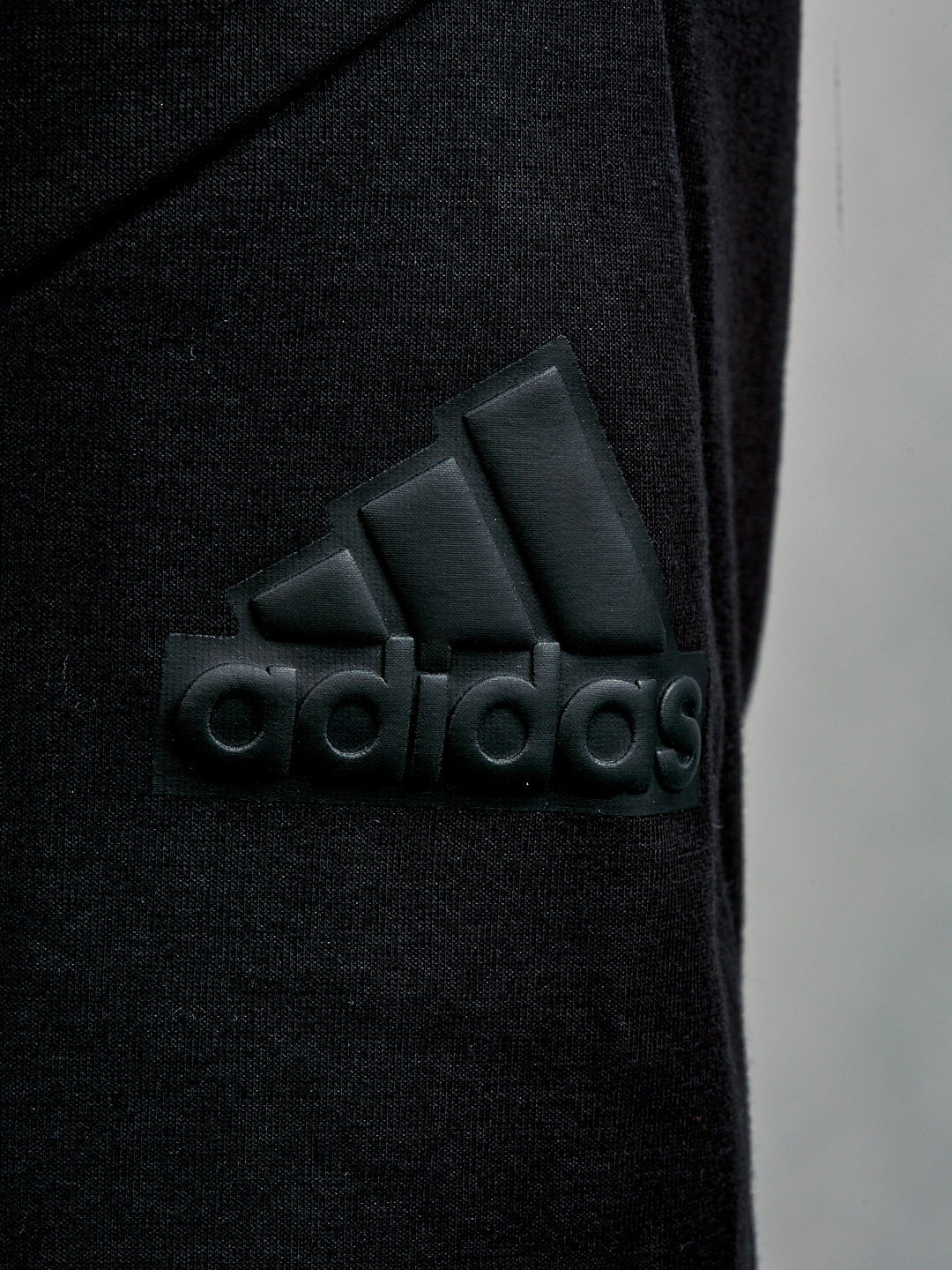 Adidas men's black shorts with a colorful logo